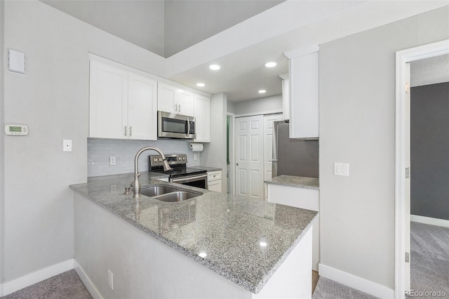 4076 S Carson St Unit H, Aurora, CO 80014 - kitchen featuring stainless steel appliances, white cabinetry, light stone counters, decorative backsplash, and light carpet