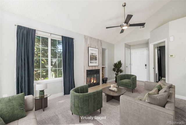 4076 S Carson St Unit H, Aurora, CO 80014 - living area with carpet, vaulted ceiling, a tiled fireplace, and ceiling fan