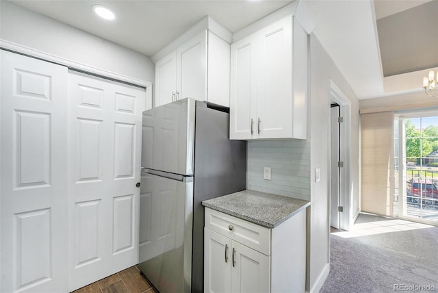 4076 S Carson St Unit H, Aurora, CO 80014 - kitchen featuring freestanding refrigerator, white cabinets, light stone counters, tasteful backsplash, and recessed lighting