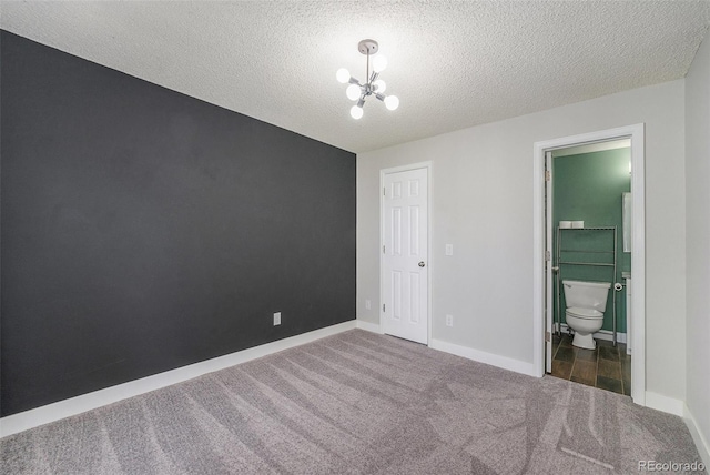 4076 S Carson St Unit H, Aurora, CO 80014 - unfurnished bedroom with carpet, a chandelier, a textured ceiling, and ensuite bath