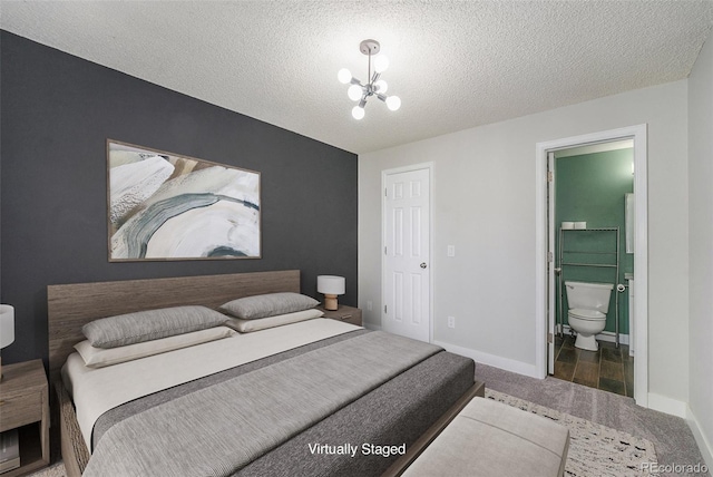 4076 S Carson St Unit H, Aurora, CO 80014 - carpeted bedroom with a chandelier, a textured ceiling, and connected bathroom