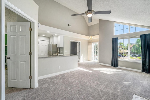 4076 S Carson St Unit H, Aurora, CO 80014 - unfurnished living room featuring carpet, a ceiling fan, a textured ceiling, and high vaulted ceiling