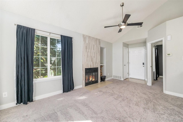 4076 S Carson St Unit H, Aurora, CO 80014 - unfurnished living room with a ceiling fan, carpet, vaulted ceiling, and a fireplace