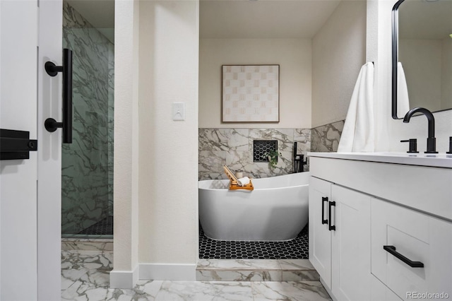 bathroom featuring shower with separate bathtub and vanity