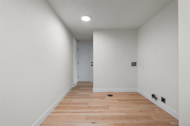 clothes washing area with washer hookup and light hardwood / wood-style flooring