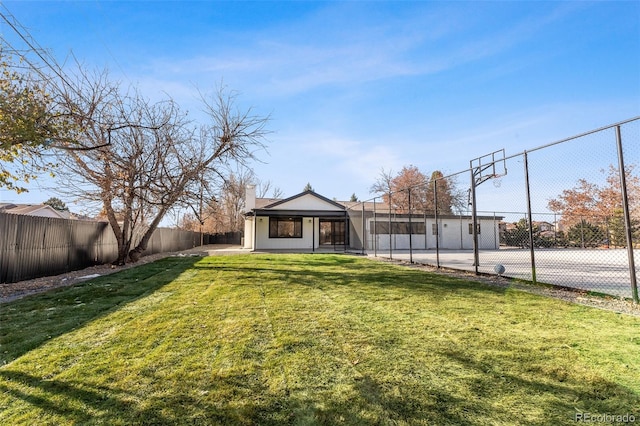 view of yard featuring basketball hoop