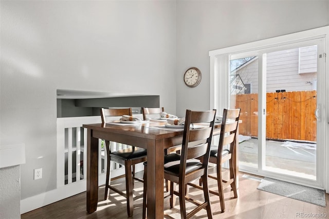 dining space with wood-type flooring