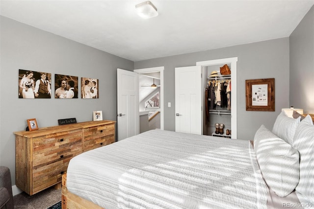 carpeted bedroom featuring a closet and a spacious closet