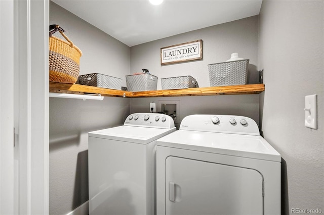 clothes washing area featuring washer and dryer