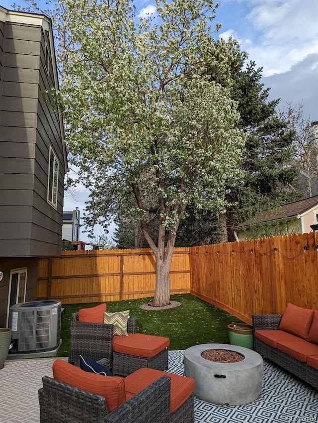 view of patio featuring an outdoor living space with a fire pit and central AC unit