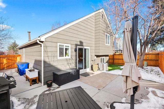 rear view of property with central AC and a patio area