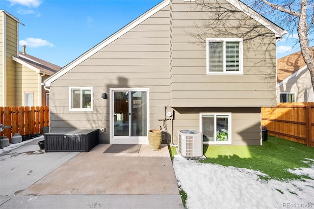 rear view of house with central AC unit and a patio area