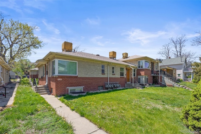 5012 W 36th Ave Unit 5, Denver, CO 80212 - rear view of property featuring brick siding, a lawn, and stairs