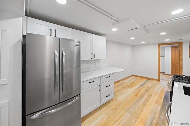 5012 W 36th Ave Unit 5, Denver, CO 80212 - kitchen featuring appliances with stainless steel finishes, white cabinetry, recessed lighting, light wood-style flooring, and baseboards