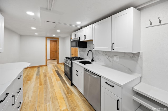 5012 W 36th Ave Unit 5, Denver, CO 80212 - kitchen featuring dishwasher, a sink, gas range, black microwave, and recessed lighting