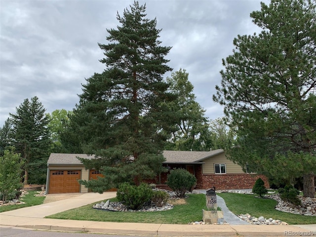 view of front of home with a front yard and a garage