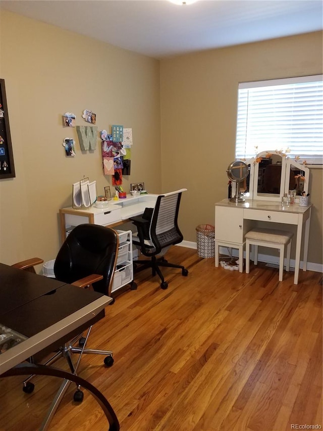 office with light hardwood / wood-style flooring