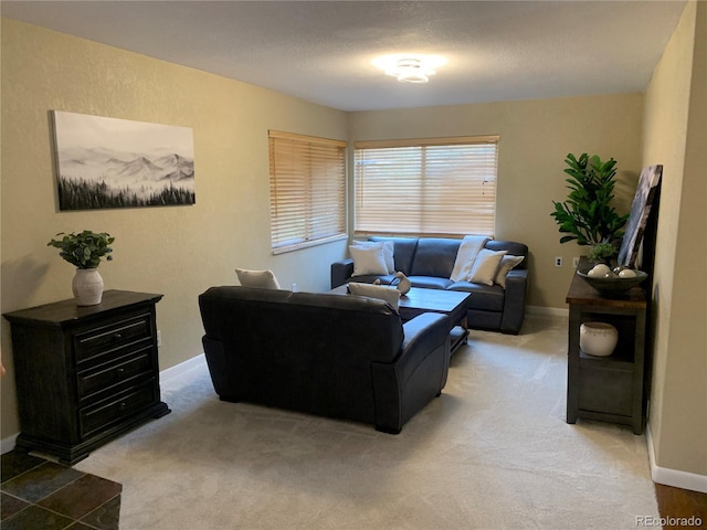 living room featuring light carpet and a textured ceiling