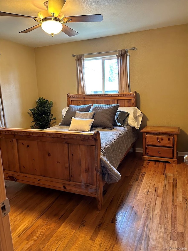 bedroom featuring ceiling fan and light hardwood / wood-style floors