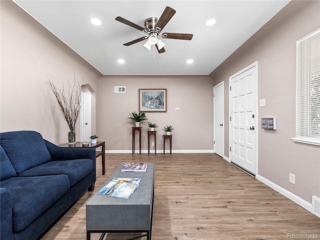 2695 S Logan St, Denver, CO 80210 - living area featuring ceiling fan, wood finished floors, recessed lighting, baseboards, and arched walkways