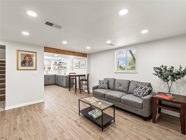 2695 S Logan St, Denver, CO 80210 - living area featuring light wood-style floors, recessed lighting, and baseboards