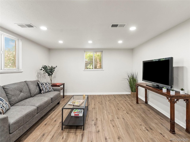 2695 S Logan St, Denver, CO 80210 - living area with wood finished floors, baseboards, and recessed lighting