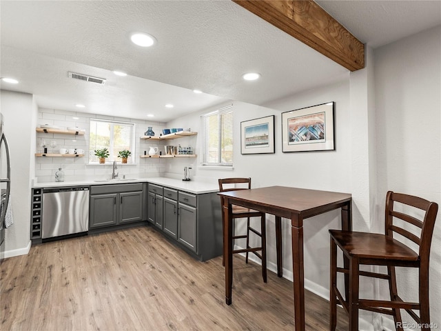 2695 S Logan St, Denver, CO 80210 - kitchen with stainless steel dishwasher, gray cabinets, open shelves, healthy amount of natural light, and recessed lighting