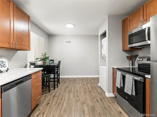 2695 S Logan St, Denver, CO 80210 - kitchen featuring appliances with stainless steel finishes, light wood-style floors, light countertops, and baseboards