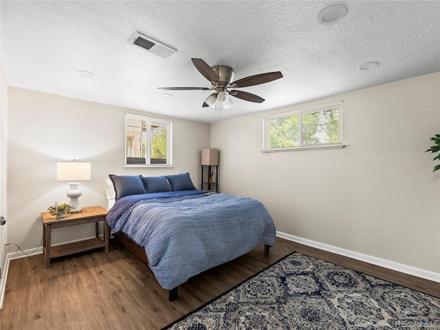 2695 S Logan St, Denver, CO 80210 - bedroom with baseboards, wood finished floors, ceiling fan, and a textured ceiling