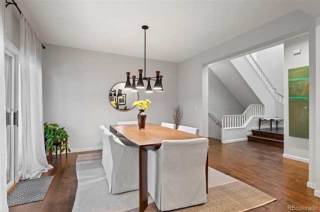 dining space with a chandelier and dark hardwood / wood-style floors