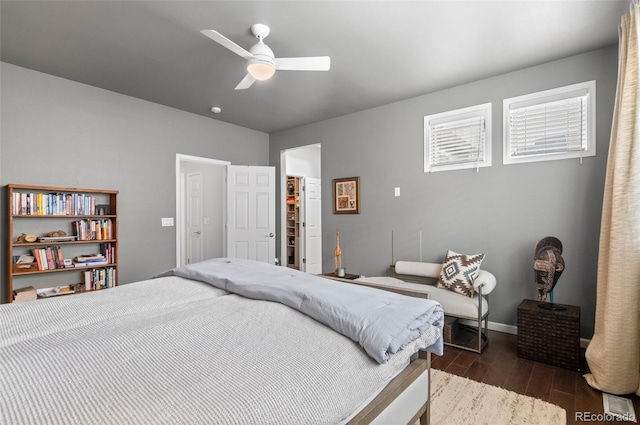 bedroom with dark hardwood / wood-style floors and ceiling fan