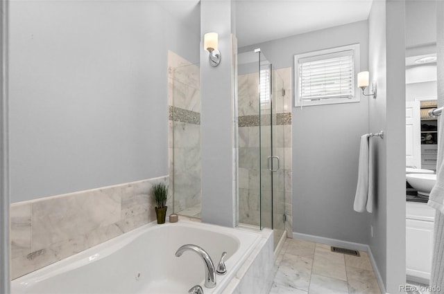 bathroom with shower with separate bathtub