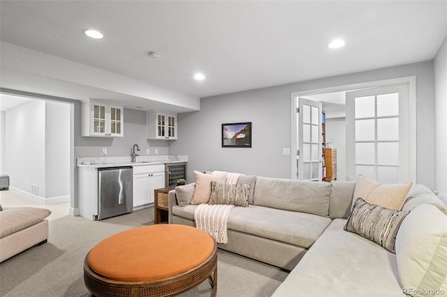 living room featuring indoor wet bar, light colored carpet, and wine cooler