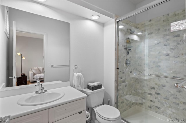 bathroom featuring vanity, toilet, and walk in shower