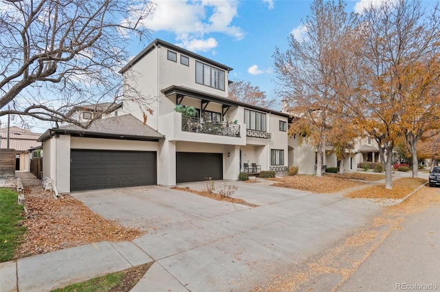 view of front of home with a balcony and a garage