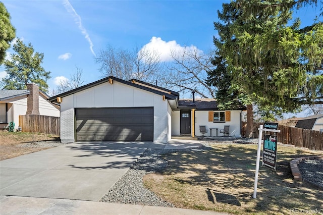 8334 Allison Ct, Arvada, CO 80005 - view of front of home featuring an attached garage, brick siding, and driveway
