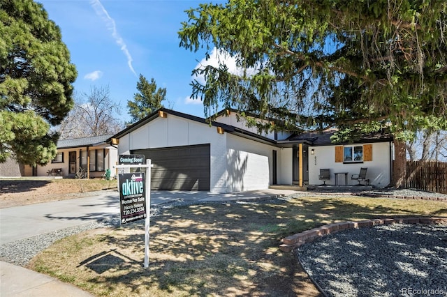 8334 Allison Ct, Arvada, CO 80005 - ranch-style house featuring a garage, driveway, brick siding, and board and batten siding