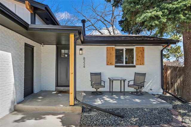 8334 Allison Ct, Arvada, CO 80005 - view of exterior entry with brick siding and a patio
