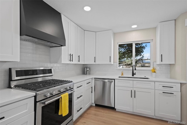 8334 Allison Ct, Arvada, CO 80005 - kitchen with stainless steel appliances, custom range hood, a sink, light countertops, and recessed lighting
