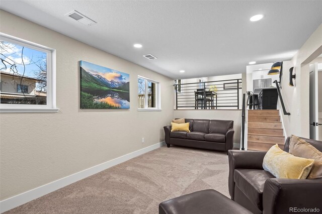 8334 Allison Ct, Arvada, CO 80005 - living area featuring light colored carpet, baseboards, recessed lighting, and stairs