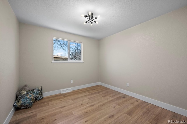 8334 Allison Ct, Arvada, CO 80005 - empty room with light wood-style flooring, baseboards, and a textured ceiling
