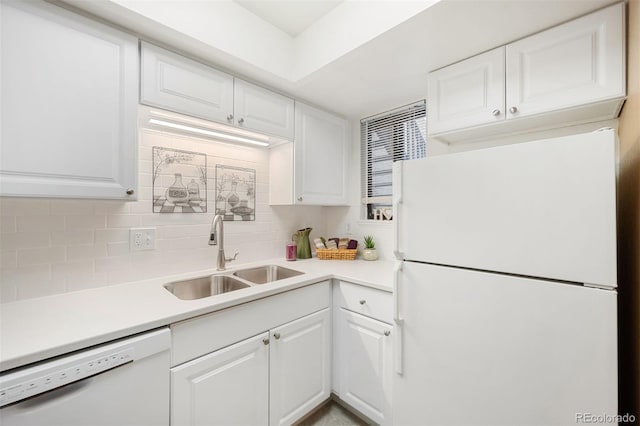 kitchen featuring sink, backsplash, white cabinets, and white appliances