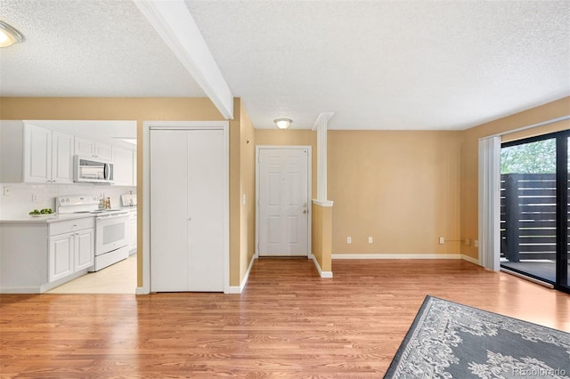 interior space featuring light hardwood / wood-style flooring and a textured ceiling