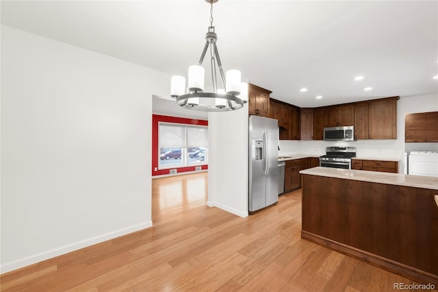 kitchen featuring baseboards, light countertops, recessed lighting, light wood-style flooring, and appliances with stainless steel finishes