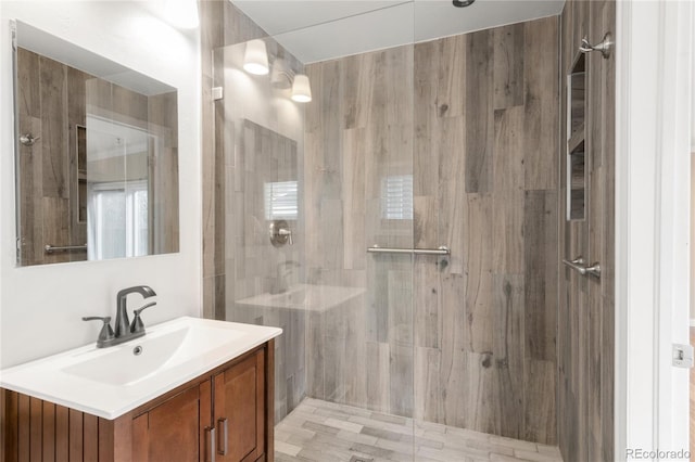 bathroom with a stall shower and vanity