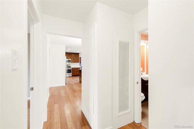 corridor featuring light wood-style floors