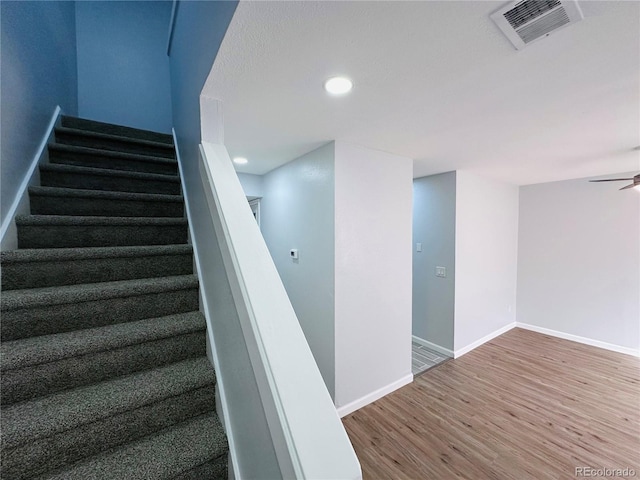 stairway featuring visible vents, a ceiling fan, wood finished floors, recessed lighting, and baseboards