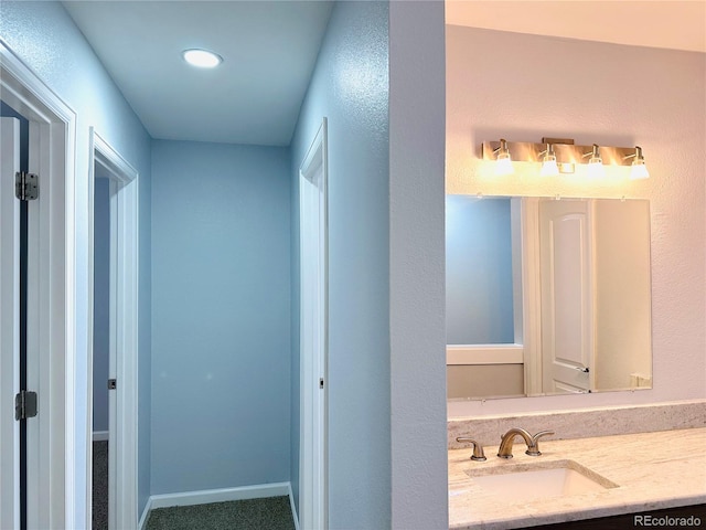 bathroom featuring vanity and baseboards