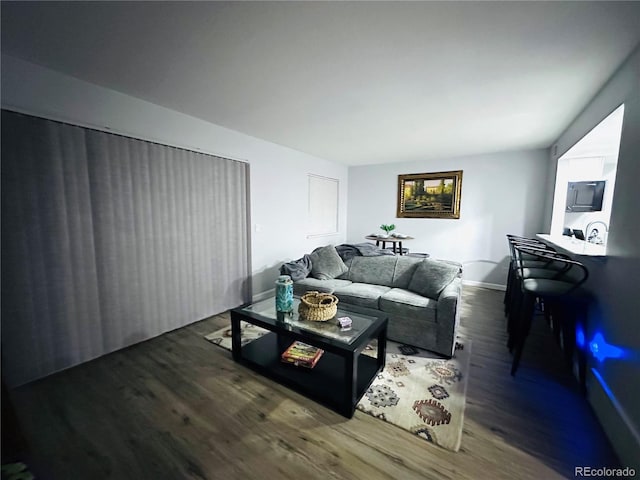 living room featuring baseboards and wood finished floors