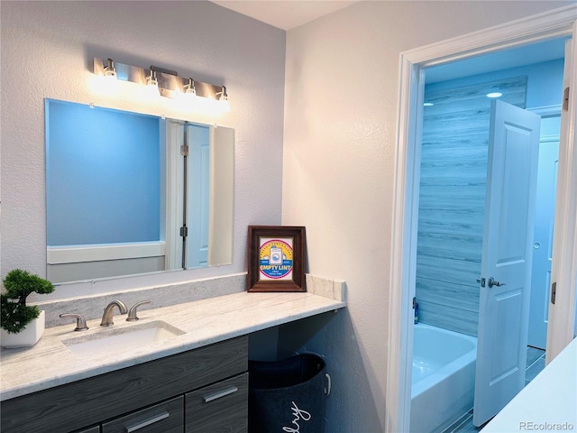 full bathroom with vanity and a tub